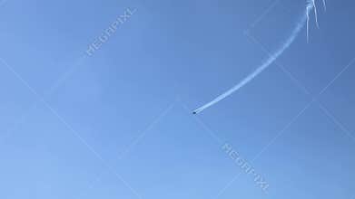 The F16 fighter performs aerobatics over the sea against the background of mountains