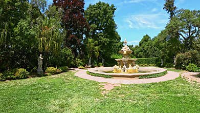 footage of a water fountain with lush green trees and flowers at Huntington Library and Botanical Gardens in San Marino California