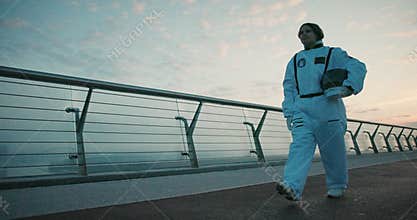 Female astronaut in space suit confidently walking on Mars. Hispanic woman cosmonaut exploring deep cosmos. Cyber punk aesthetics