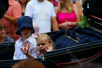 Children in carriage waving