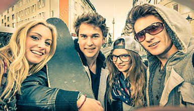 Young hipster best friends taking a selfie in urban city context
