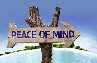 Peace of Mind wooden sign with a beach on background