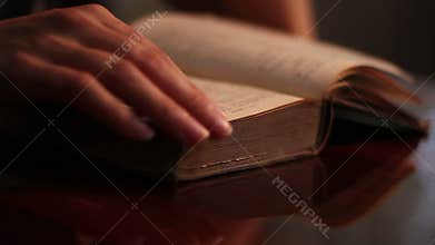 Woman Searches an Old Book