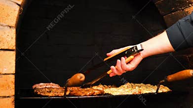 Meat for the Grill. Appetizing, delicious Barbecue and Grill . Pork Steaks, Sausages, and Chicken Breasts on the Grates