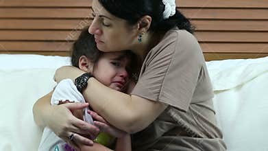 Girl crying in the bedroom. Her mother teaching to be good