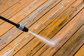 Wooden deck floor cleaning with high pressure water jet.