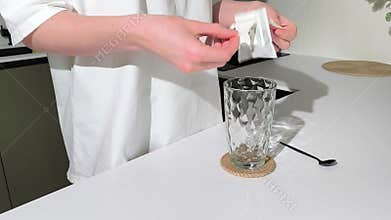 Drip coffee bag is placed on glass for brewing at