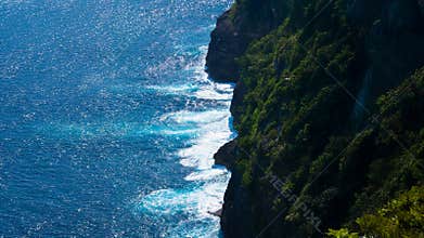 Steep Green Coastline Overlooking Crystal Blue Sea