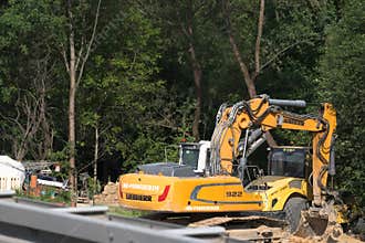 Poland, Lesser Poland Voivodeship May 31, 2026 16:16. Bomag road roller and Liebher crawler excavator on a road construction site.
