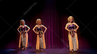 Three Heritage Performers Standing Before Theater Curtain