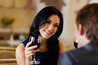 Young happy couple romantic date drink glass of