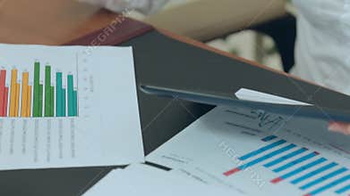 Table in the office with papers, reports,