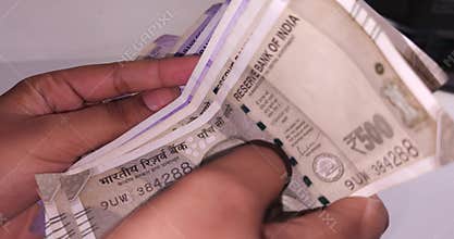 Close Up of Hands Counting Indian Rupee Currency Notes