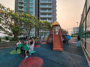 Kids play at a high-rise apartment playground