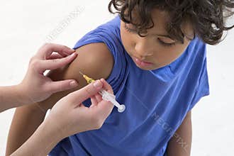 Boy receiving vaccine in the arm