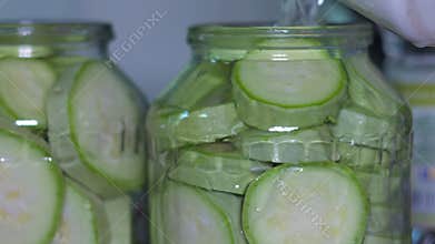 Fresh Sliced Green Zucchini Vegetables Being Poured into Glass Canning Jars