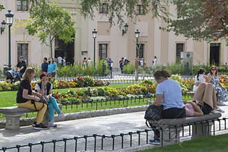 People relaxing in historic city garden