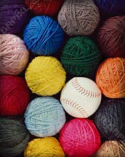 Round balls of yarn with a softball