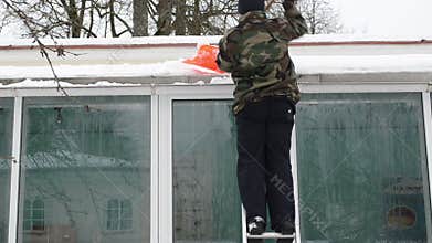 Man ladder shovel tool clean snow roof winter