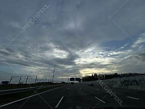 Driving on A10 Ring Road at Golden Hour Through Amsterdam Zuidas Business