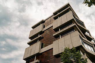 Modernist Concrete Office Building Under Cloudy Sky