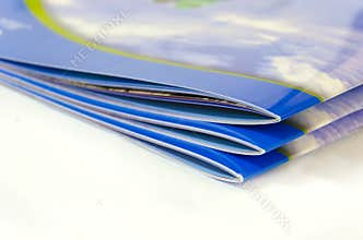 Stack of magazines on white background