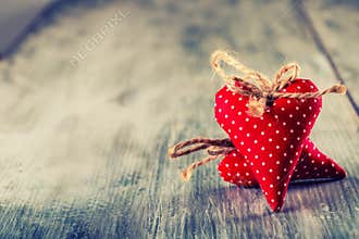 Valentines day. Red cloth handmade hearts on wooden background