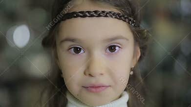 Portraits of children at shop, female child doing facial expressions and smiling