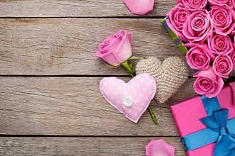 Valentines day background with gift box full of pink roses and h