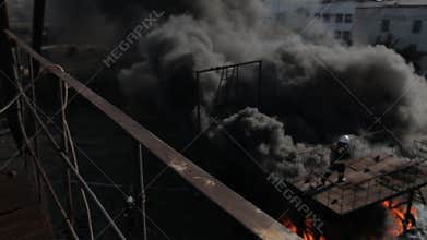 Firefighters wearing gas masks do their work in