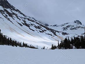 Beautiful mountain peek with clouds above Upper Dewy Lake