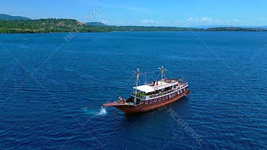 Tourists enjoying boat trip jumping into ocean. Magic aerial view drone