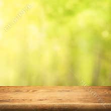 Wood table on green summer forest background