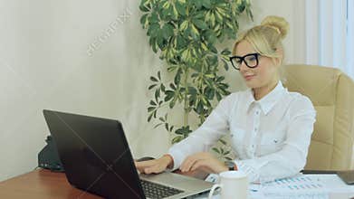 Beautiful secretary working at a computer