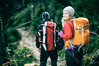 Couple hikers walking in mountains
