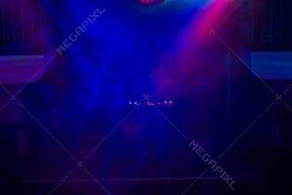 DJ and Turntable on Stage in Night Club