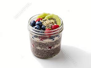 Delicious chia pudding layered with yogurt and topped with fresh blueberries raspberries kiwi slices and seeds