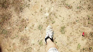 Man Walking on dirt and grass