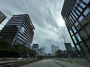 Street level view of modern high rise office towers along roadway in