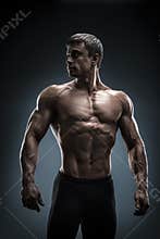 Stunning muscular young men bodybuilder looking behind