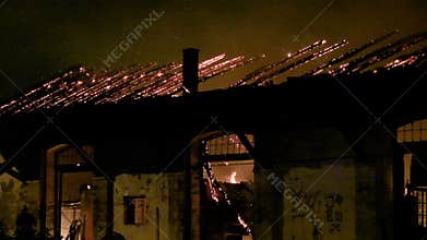 A fire in a warehouse at night