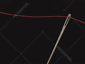 Needle and red yarn