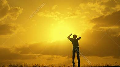 Boy winner jump top at sunset