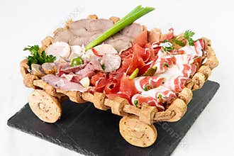 Cutting from varieties of meat products decorated with greens on