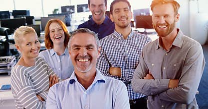 Team of business executive standing with arms crossed