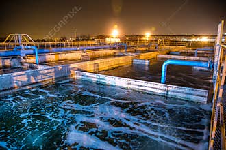 Modern wastewater treatment plant of chemical factory at night.