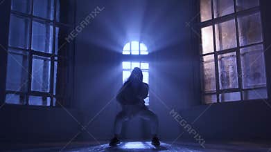 Incredibly hip-hop performed by professional dancer girl. Silhouette in moonlight