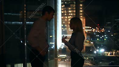 A young couple has a difficult relationship. Against the backdrop of a large window overlooking the night city