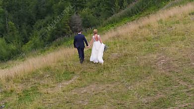 Wedding Couple Walks near Mountain Canyon