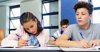 Schoolboy cheating during exam in classroom